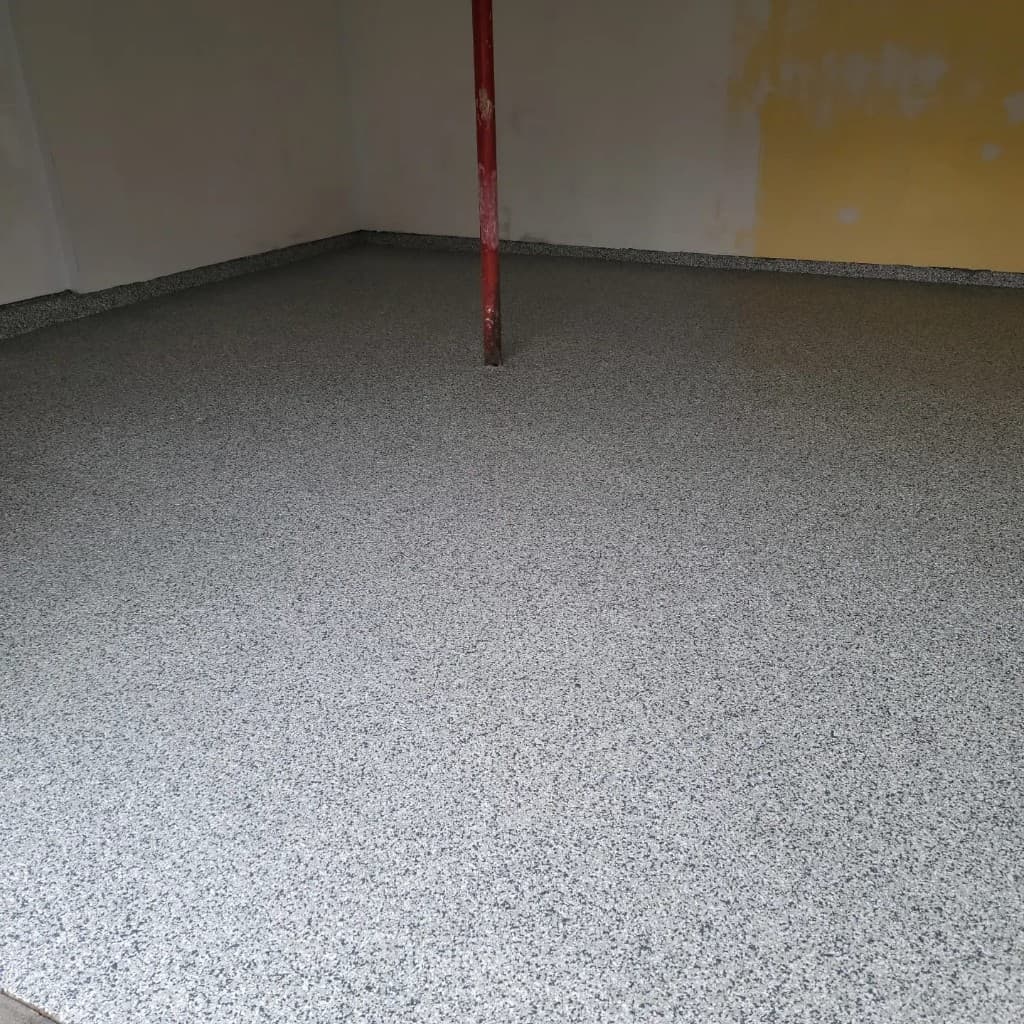 Same basement with clean full-broadcast light gray flake epoxy floor after installation