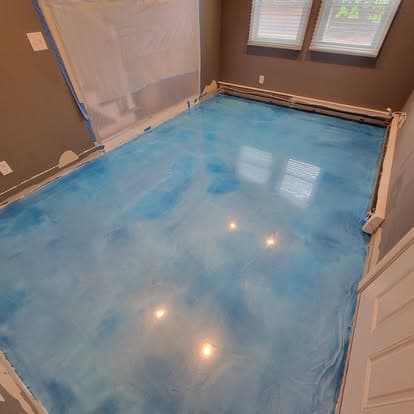 Same room with stunning sky blue metallic epoxy floor with mirror-like gloss finish