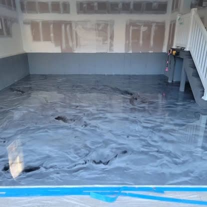 Same garage with high-gloss charcoal metallic swirl epoxy floor after installation