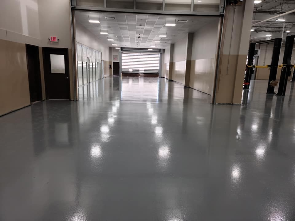 Commercial warehouse floor with gray solid epoxy and high-gloss topcoat, Long Island NY