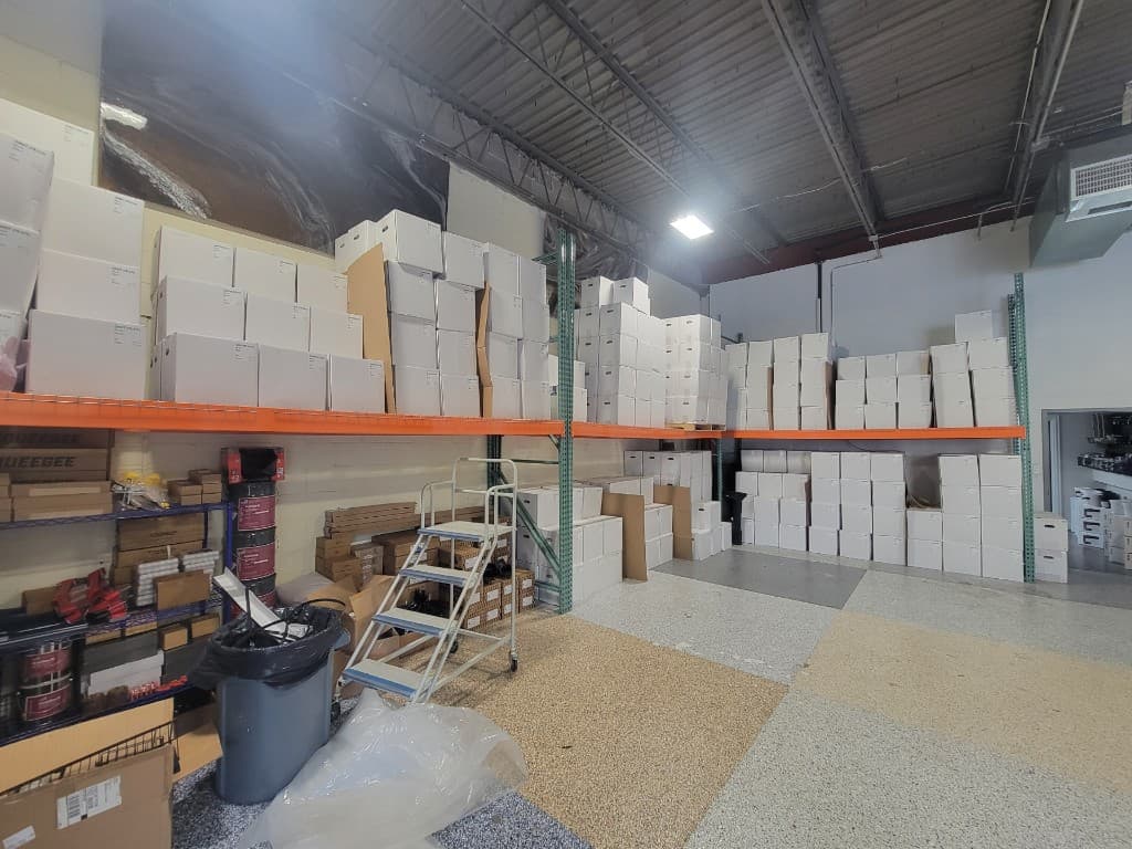 Warehouse shelving stocked with epoxy coating supplies and bulk inventory in Bohemia NY